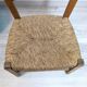 Vintage wooden and straw children's chair in a country style.