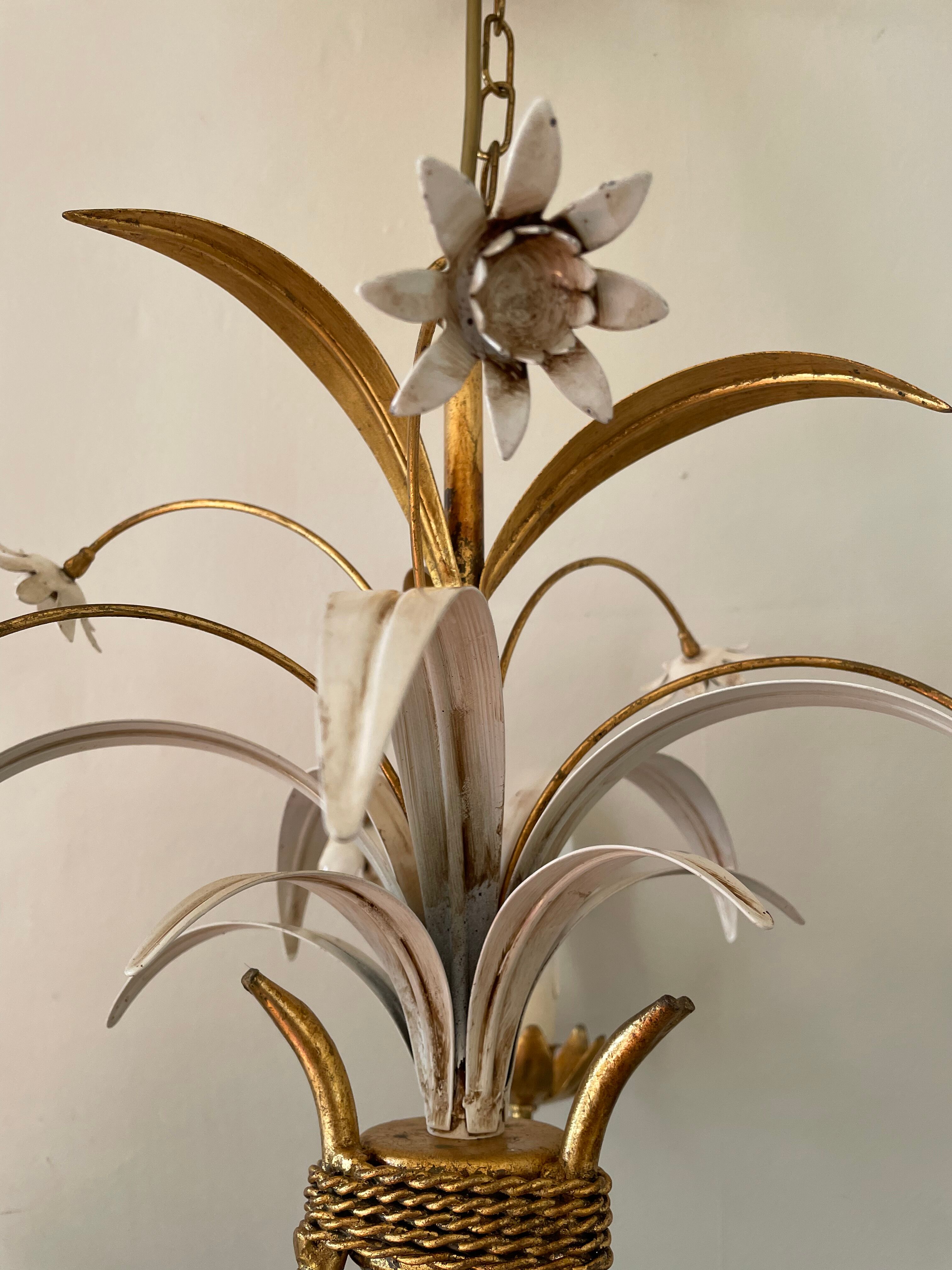 Golden metal chandelier decorated with flowers