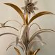 Golden metal chandelier decorated with flowers
