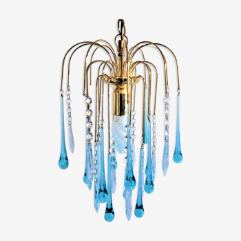 An ancient chandelier with blue tassels