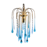 An ancient chandelier with blue tassels