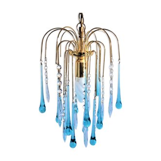 An ancient chandelier with blue tassels