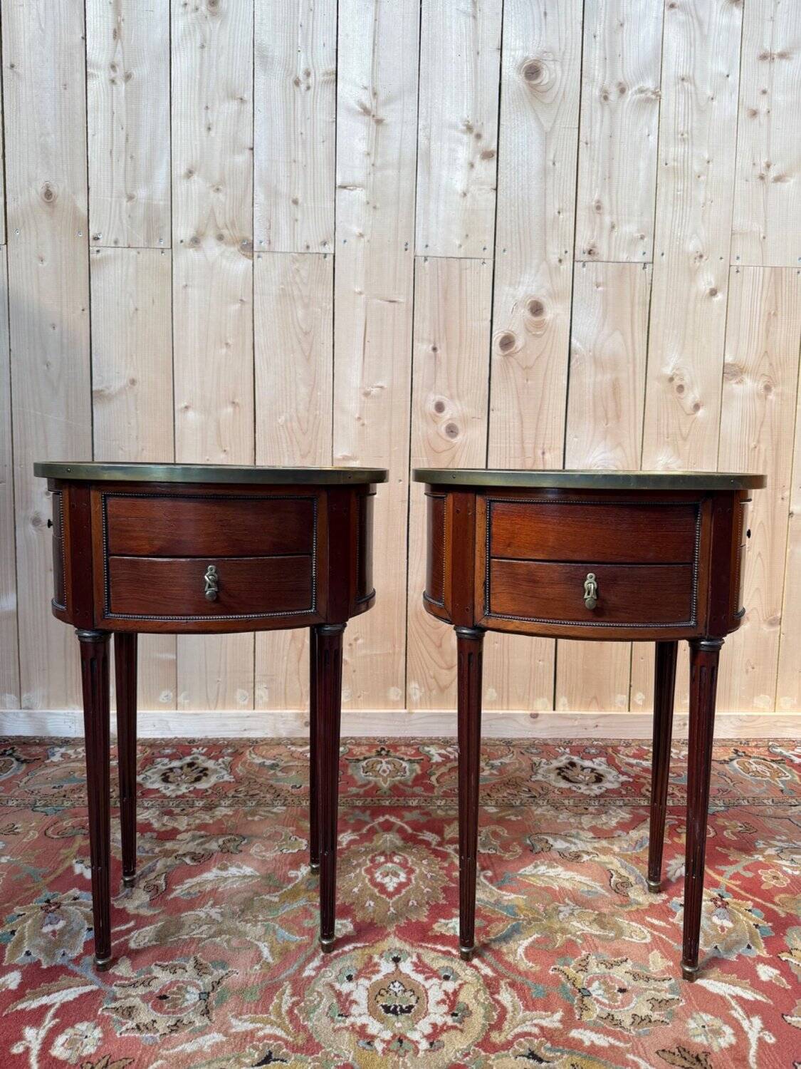 Pair of oval Louis XVI bedside tables in mahogany.