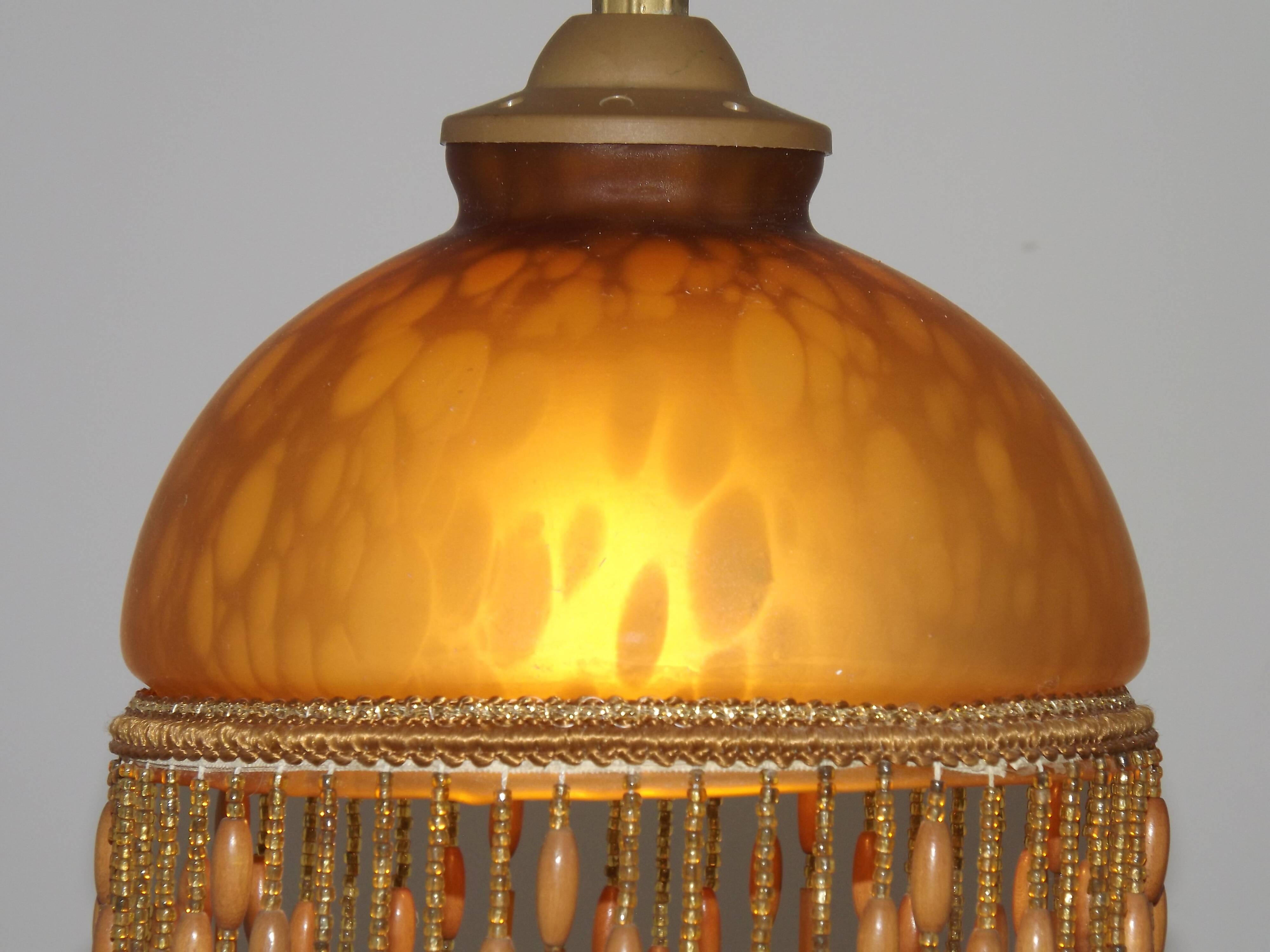Vintage French amber mottled glass hanging ceiling light with beaded fringe.