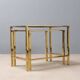 Nested tables in brass and smoked glass.