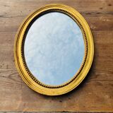 Antique gilded oval mirror