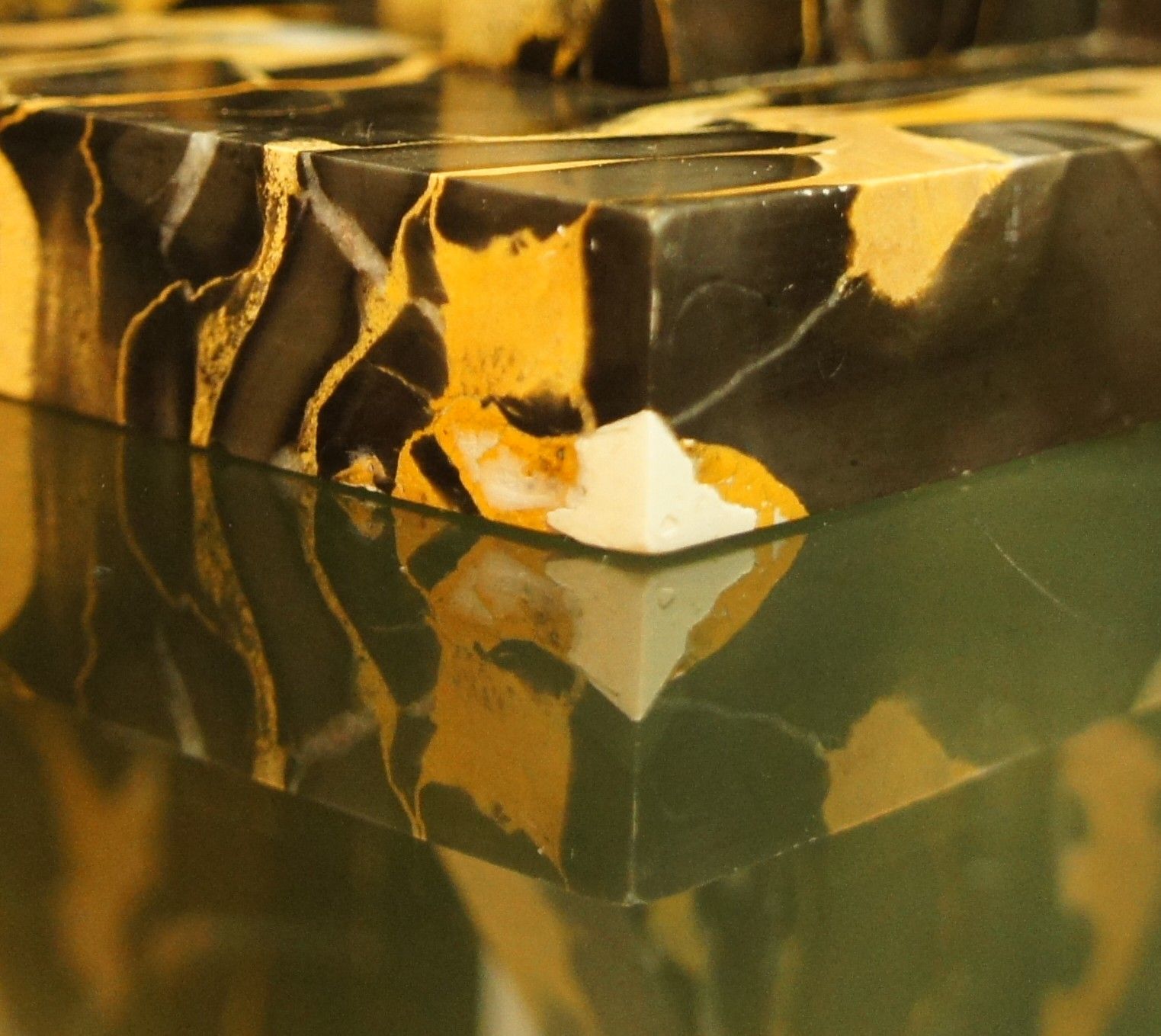 Pair of Portor marble bookends, black and golden yellow