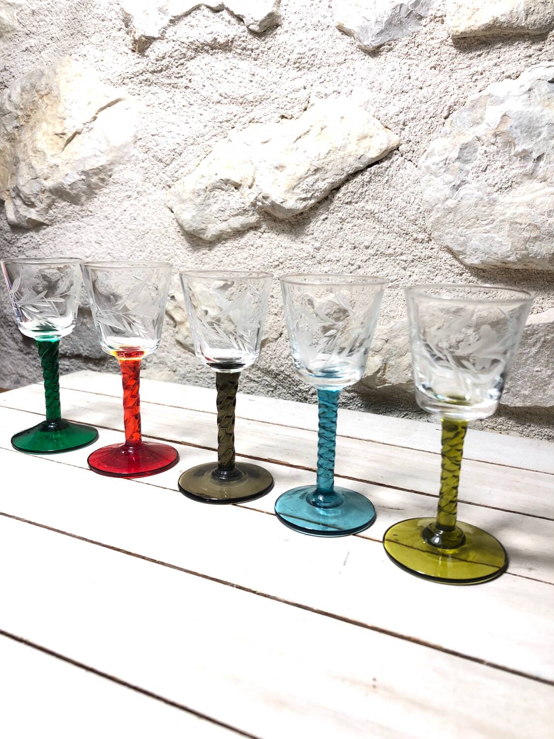 Antique and rare! Sold in a set of 12 colorful twisted stemmed glasses engraved with flowers and leaves