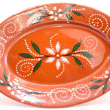 Portuguese XL dish in orange enamelled clay with unbleached flowers and green leaves
