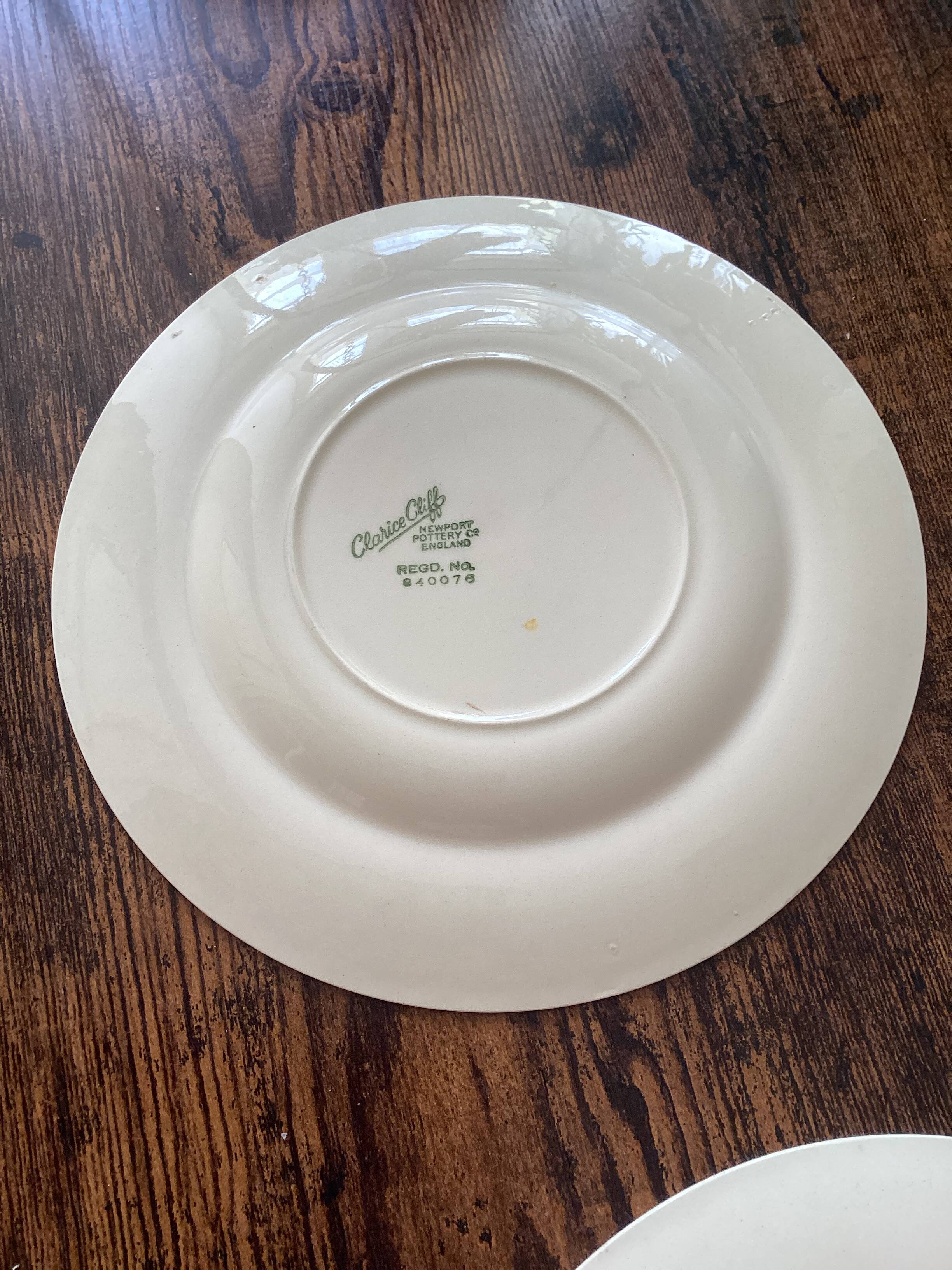 Two identical vintage Clarice Cliff plates from the Newport Pottery.
