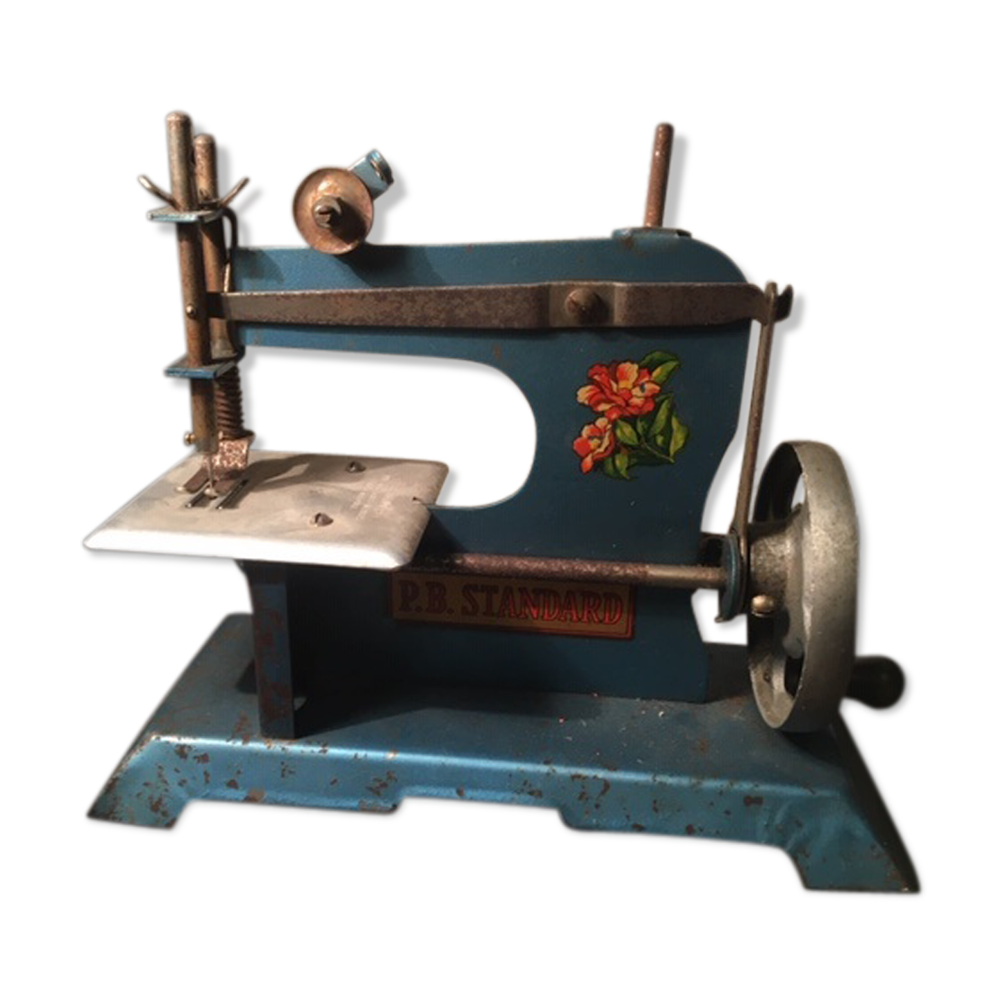 Old toy sewing machine in 1950s sheet metal