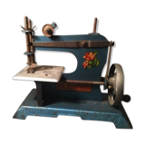 Old toy sewing machine in 1950s sheet metal