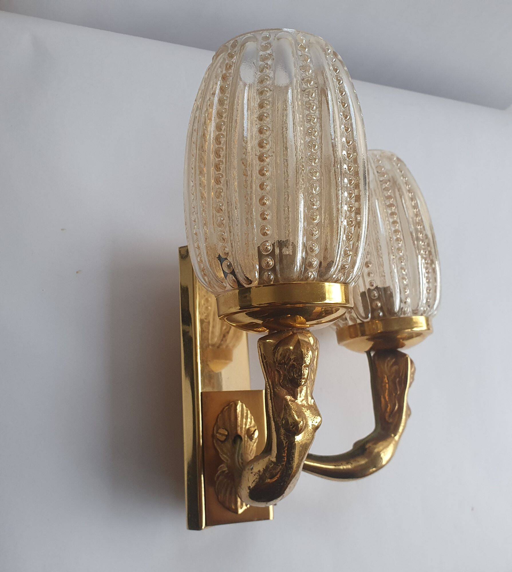 Golden bronze wall lamp with mermaids for an old bathroom.
