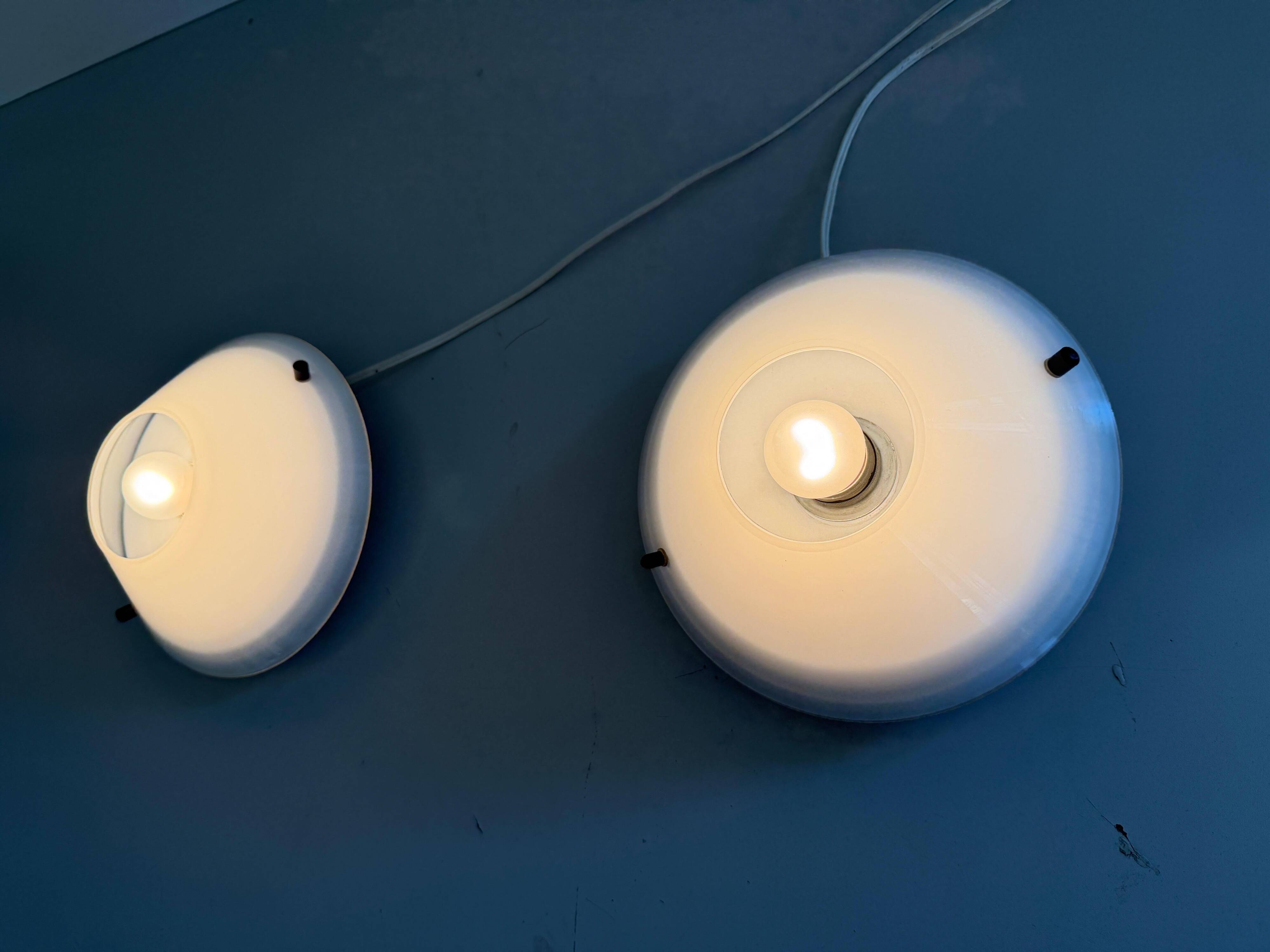 Pair of opal glass wall lights from the mid-century by Lamperti, 1960s, Italy.