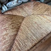 High chair made of wood and straw.