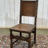 High-backed chair from the early 20th century in oak and leather