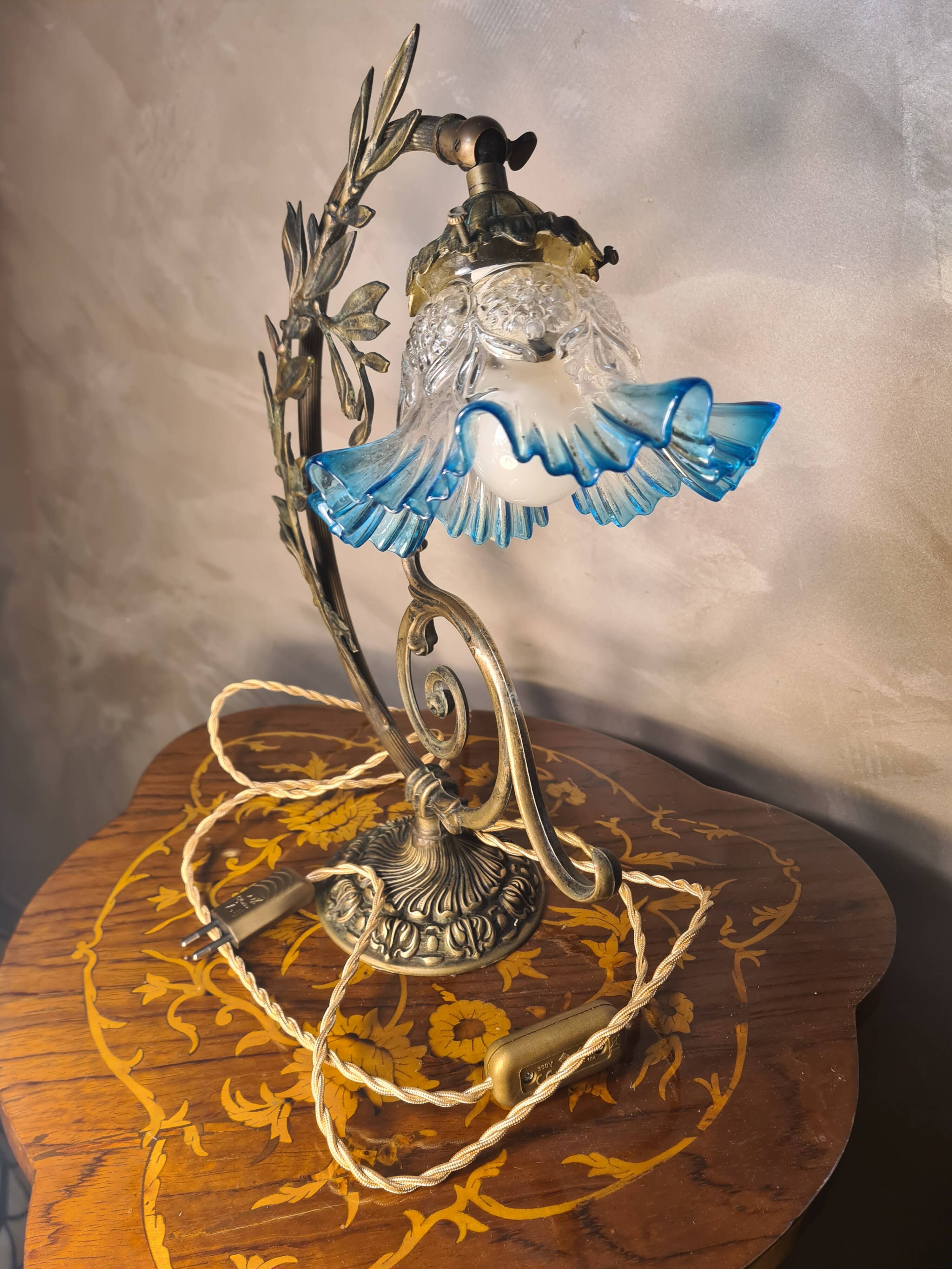 Bronze and brass lamp, transparent and blue glass shade.