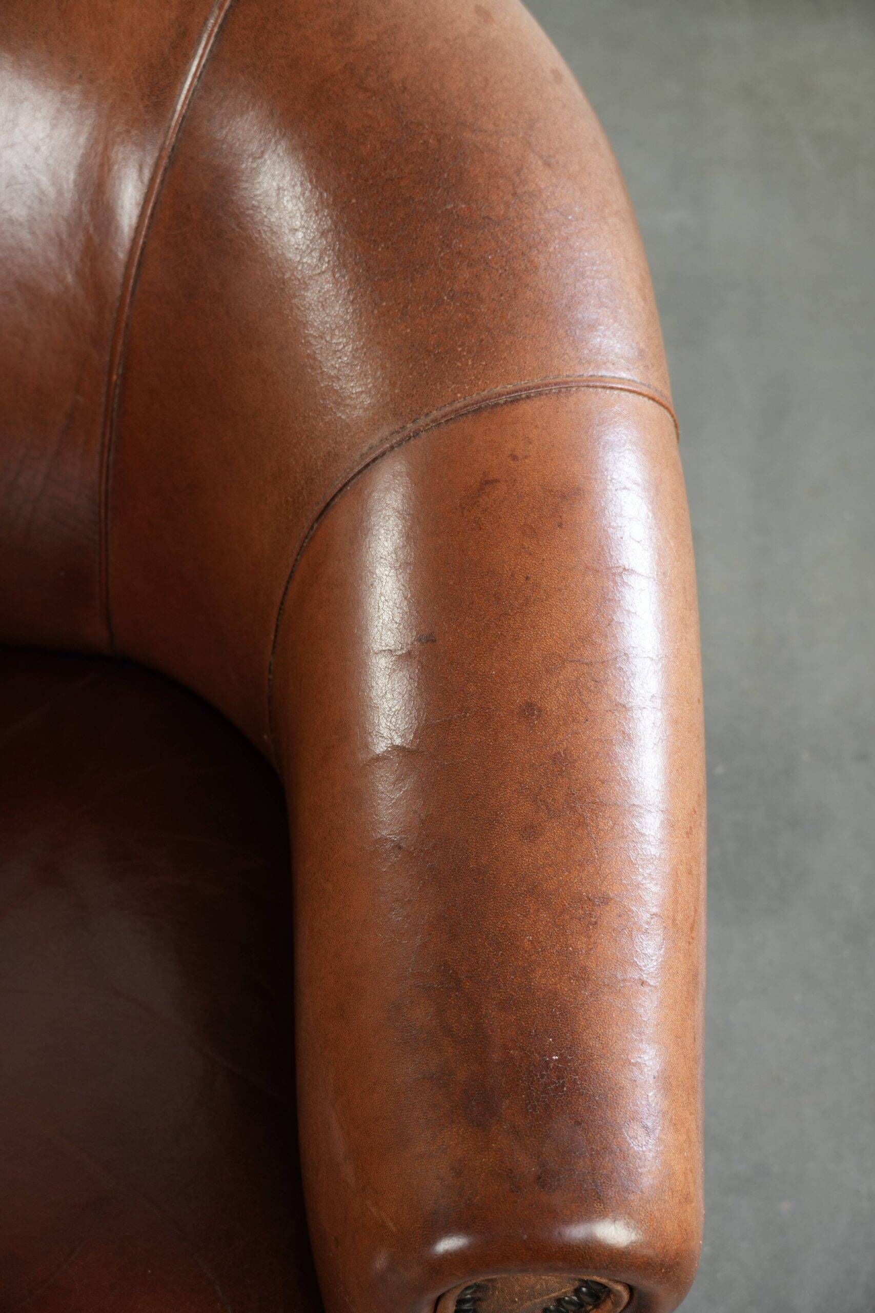 Vintage sheepskin club armchair in English style with deep colours