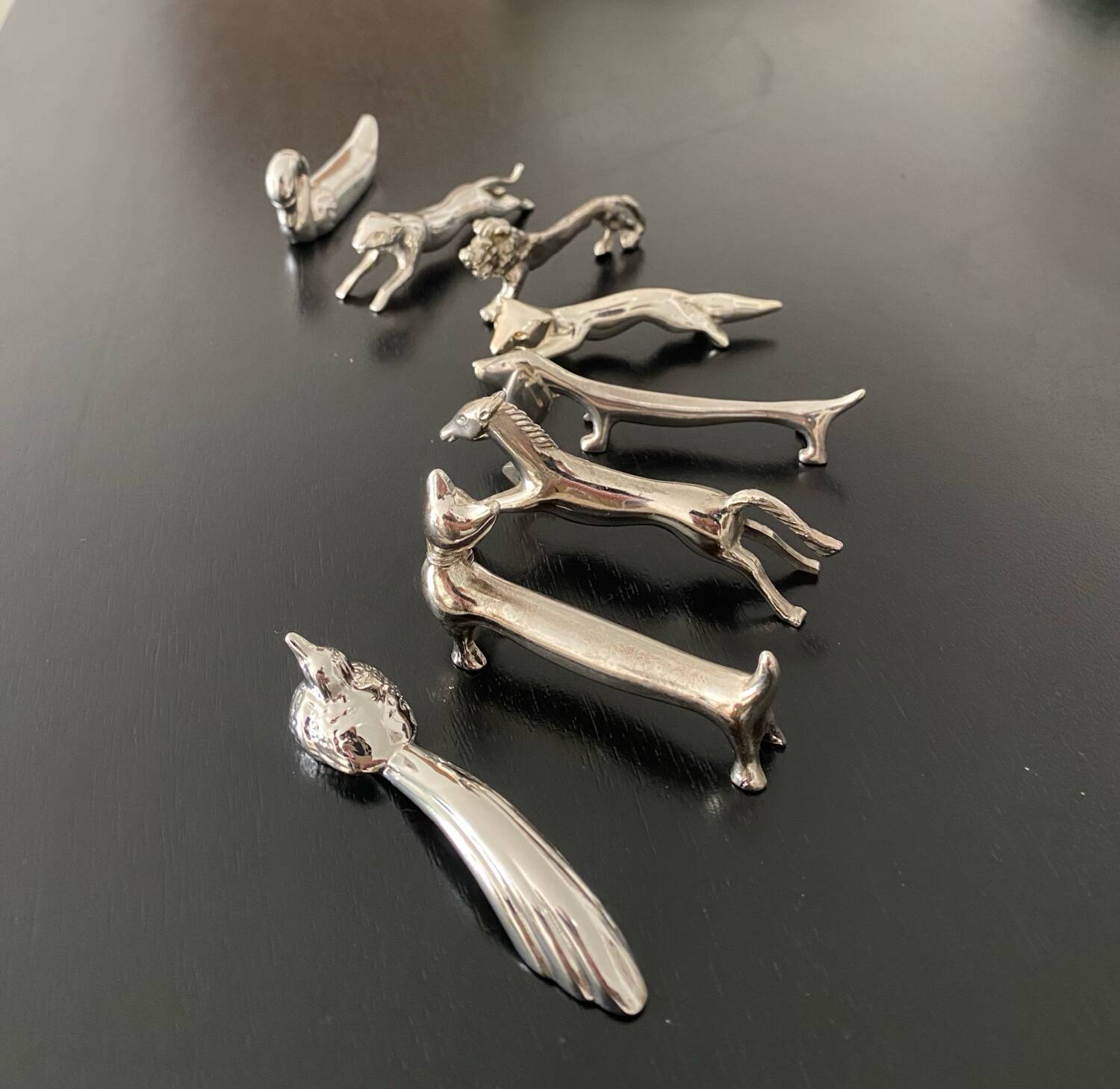 8 various animal knife holders in silver-colored metal
