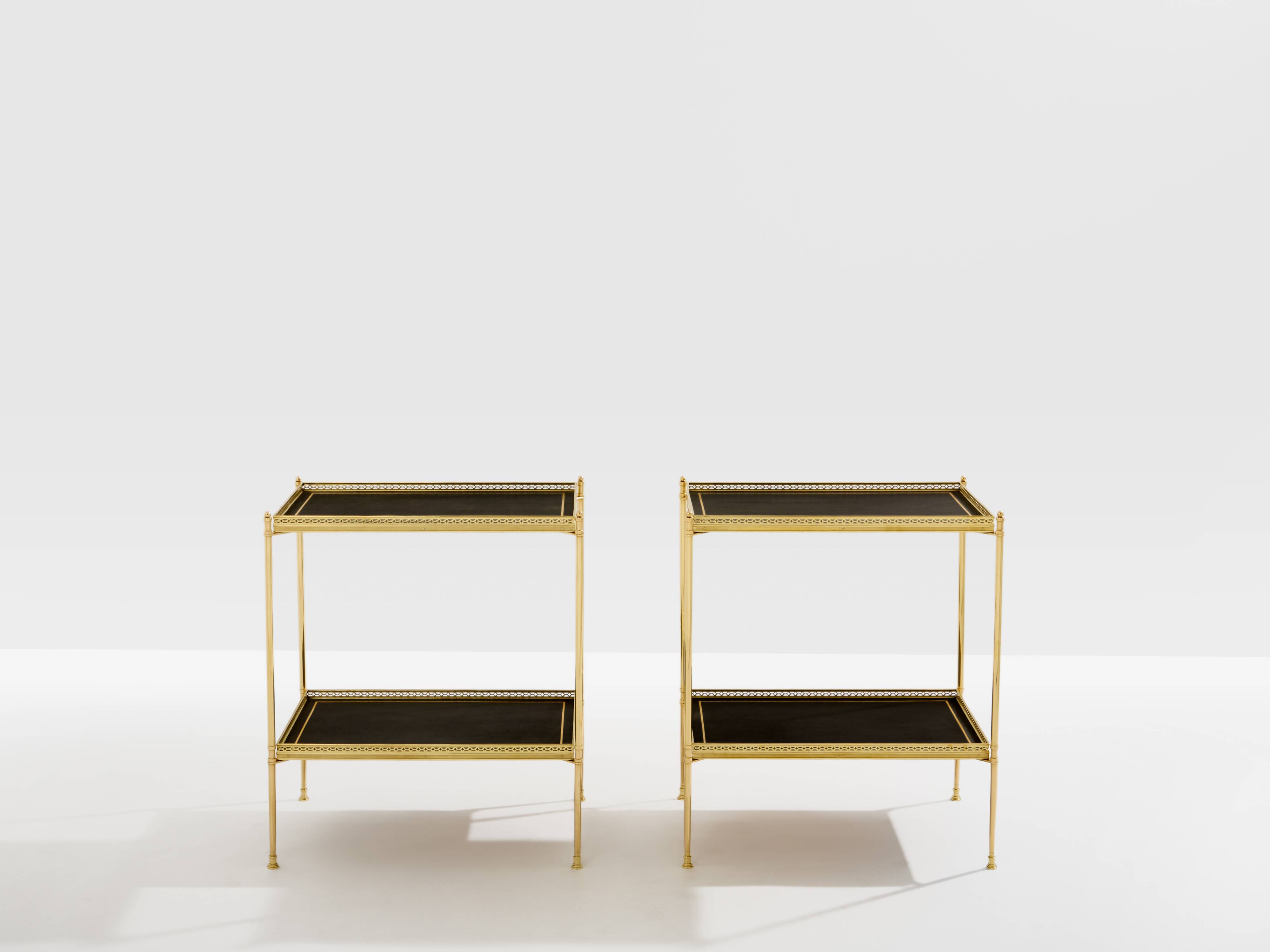 Pair of neoclassical side tables in brass and black leather by Maison Jansen, 1960.