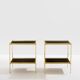 Pair of neoclassical side tables in brass and black leather by Maison Jansen, 1960.