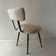 Low seat in metal and white boucle fabric.