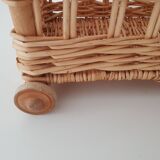 Vintage wicker basket on wheels - children's toy trolley