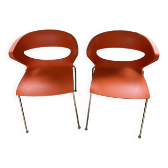 Two orange kicca chairs made in italy tbe