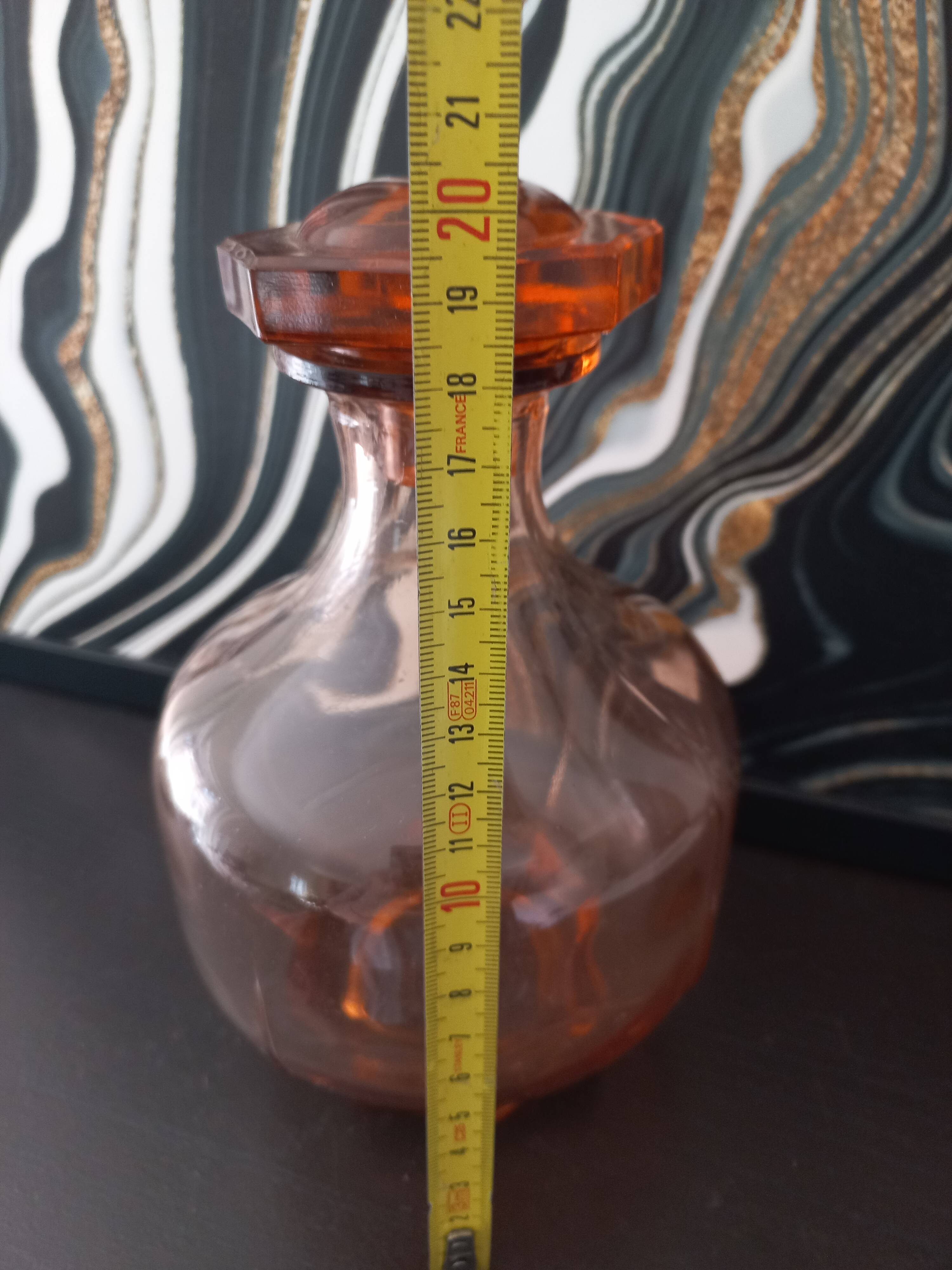 Vintage glass carafe in pink-orange, retro-chic style.
