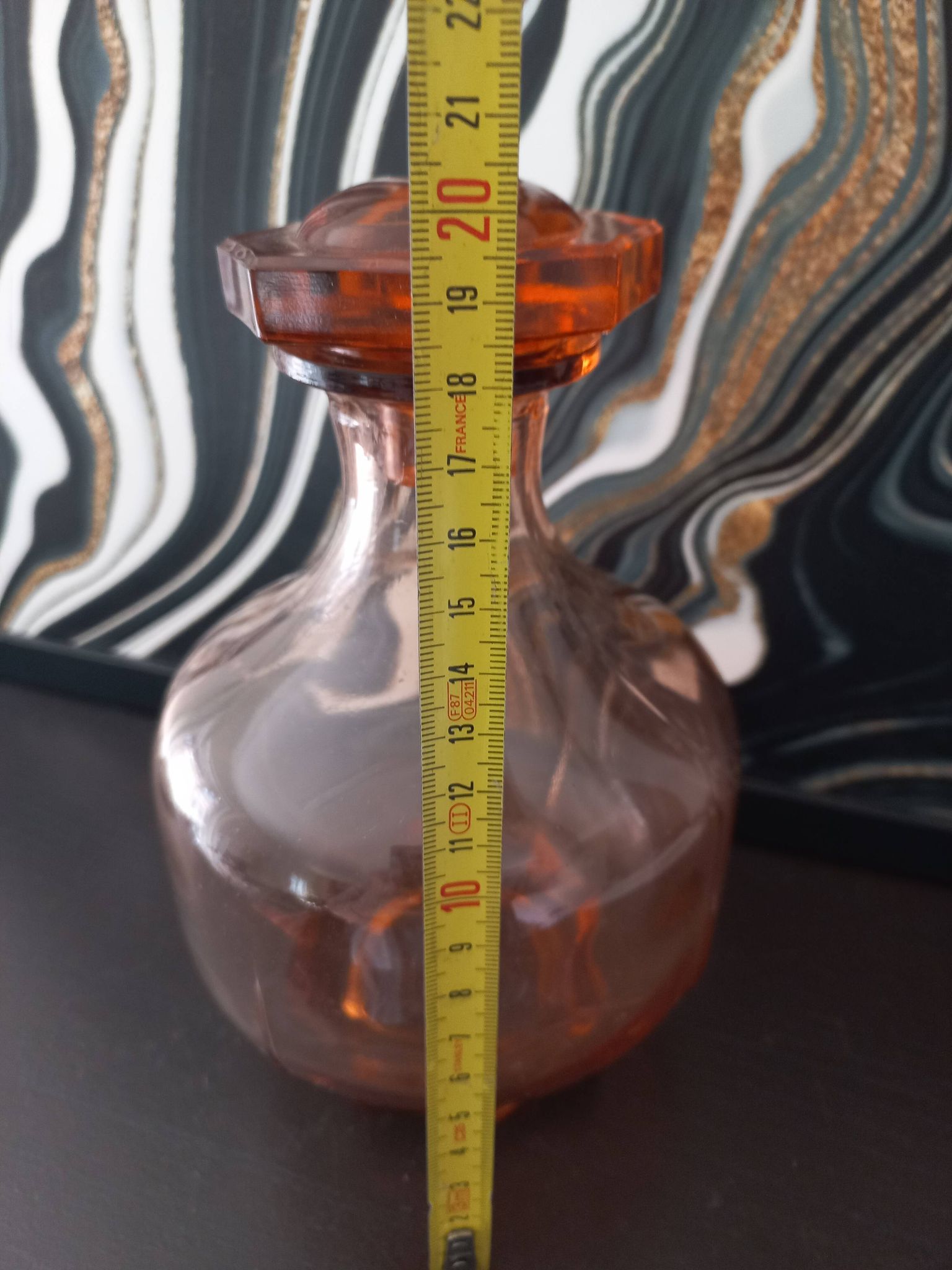 Vintage glass carafe in pink-orange, retro-chic style.