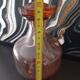 Vintage glass carafe in pink-orange, retro-chic style.