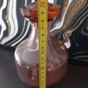 Vintage glass carafe in pink-orange, retro-chic style.