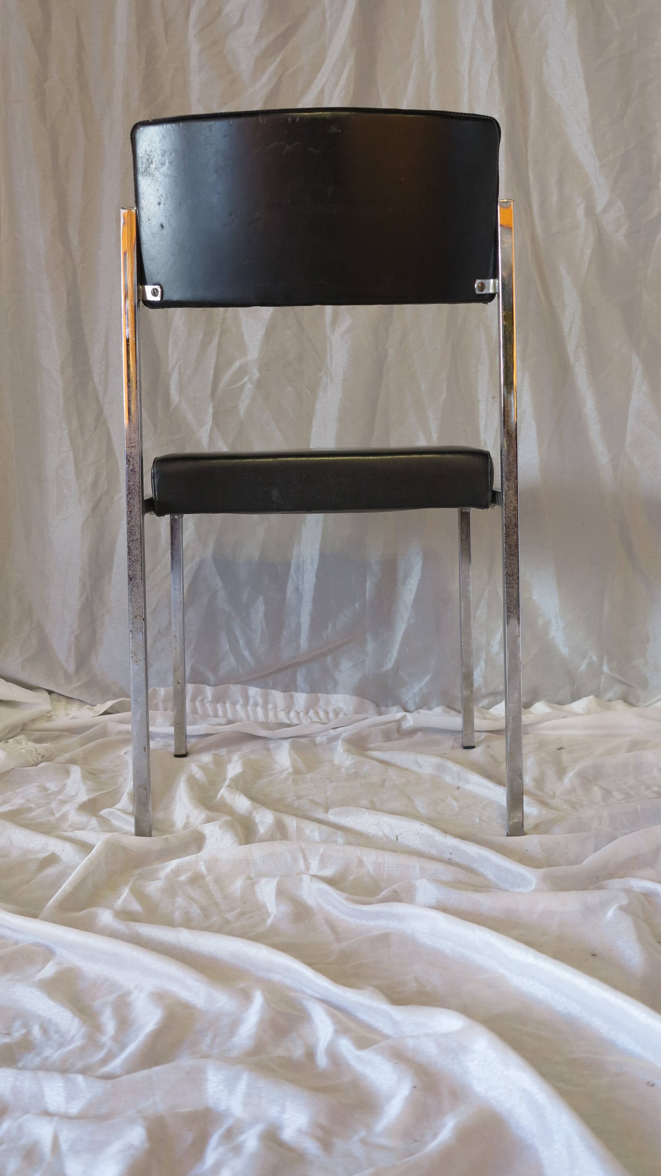 Modernist chair in chromed metal and black imitation leather