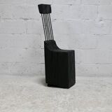 Brutalist chair, black-stained raw wood, steel. Work from the 1970s