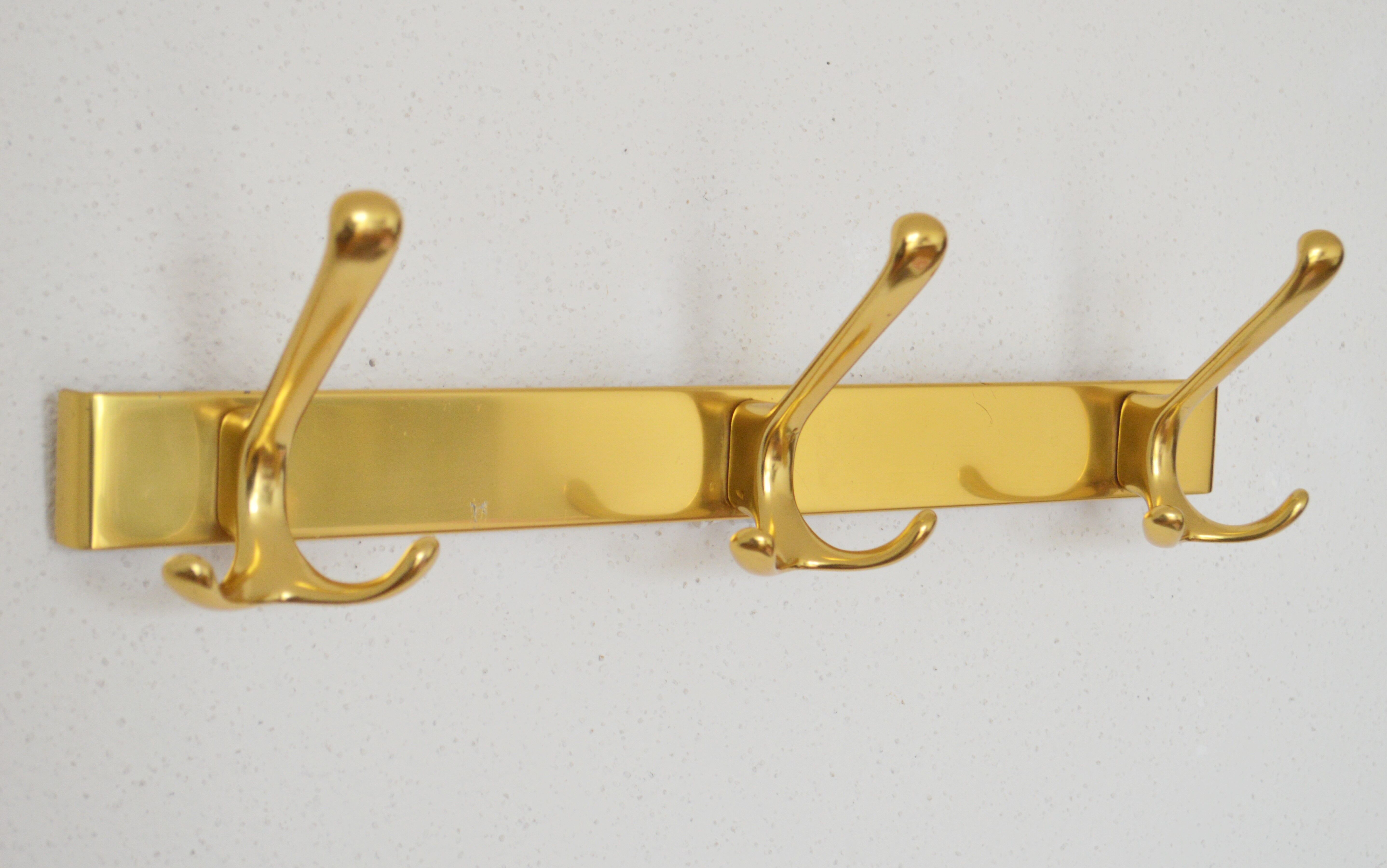 Brass wall-mounted coat rack in Bauhaus style from the 1950s