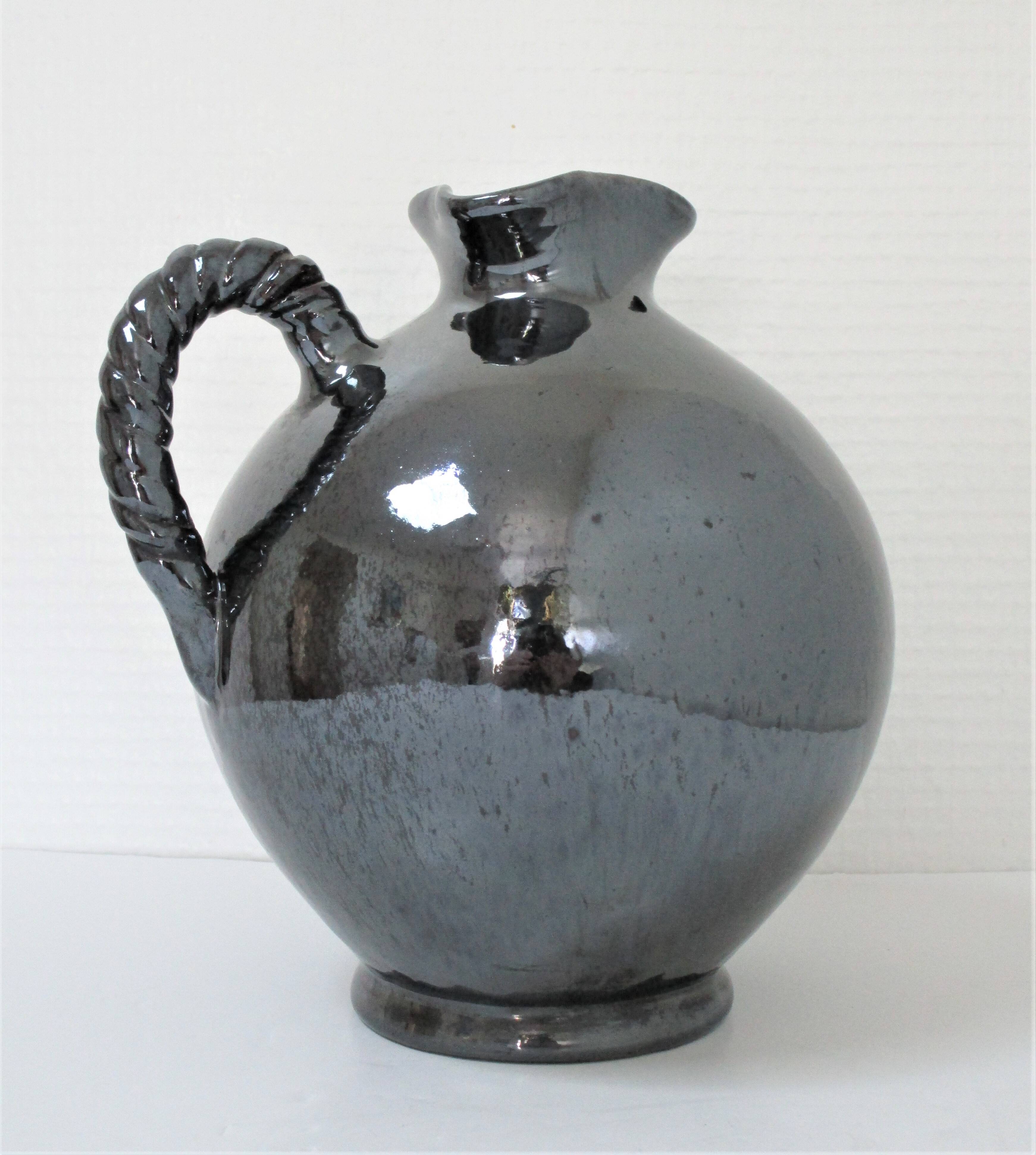Black pearl glaze ceramic pitcher by Reinhold Rieckmann signed