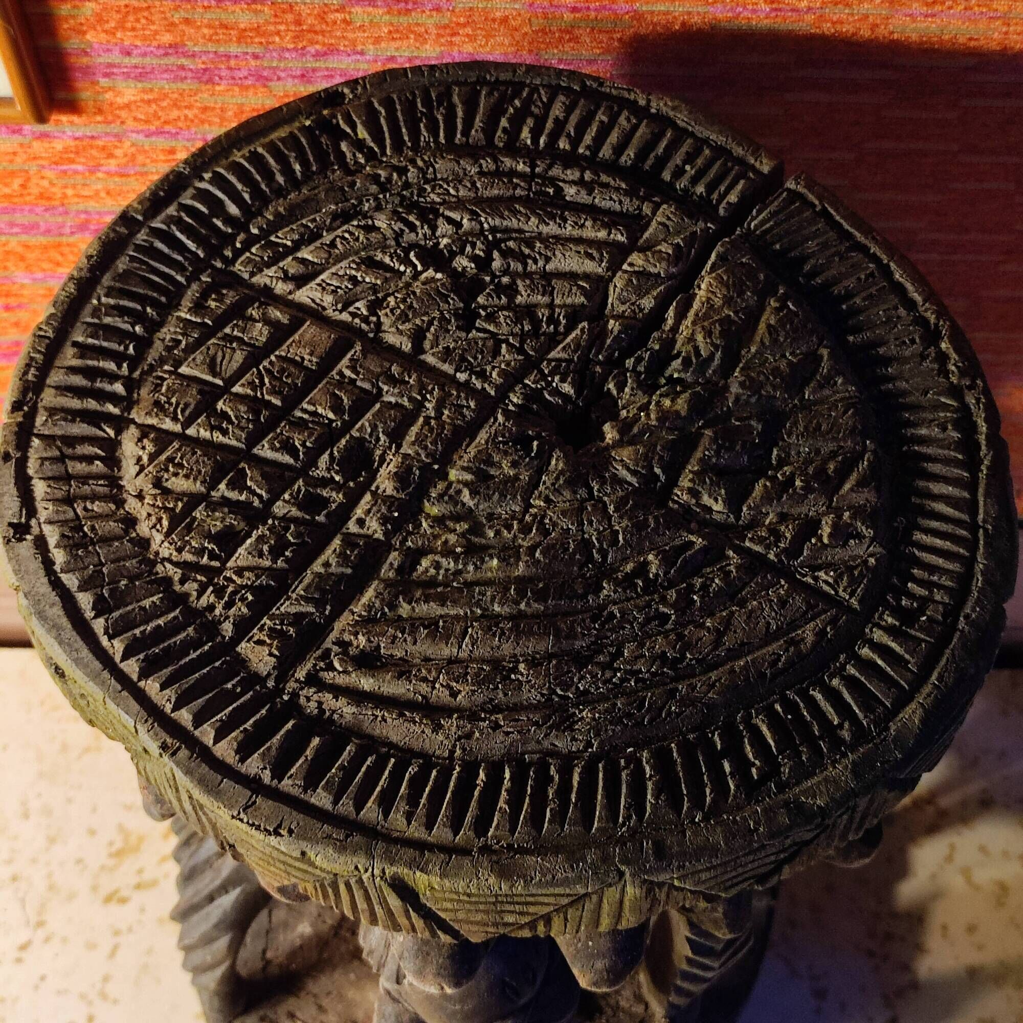 African wooden stool carved in the shapes of characters