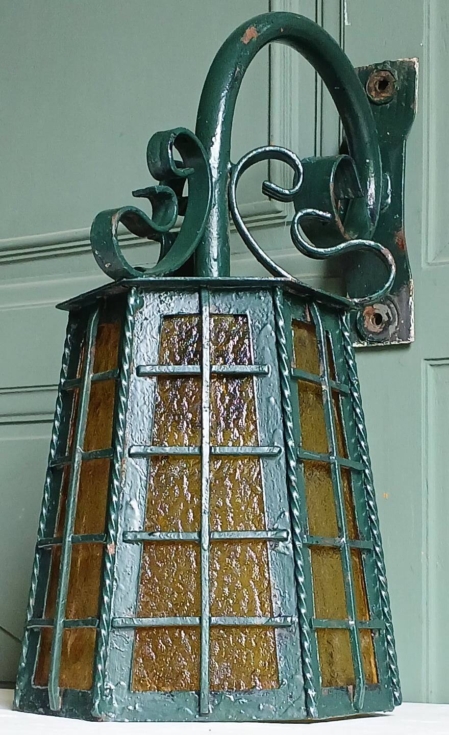 Wrought iron wall lantern & amber cathedral glass