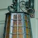 Wrought iron wall lantern & amber cathedral glass