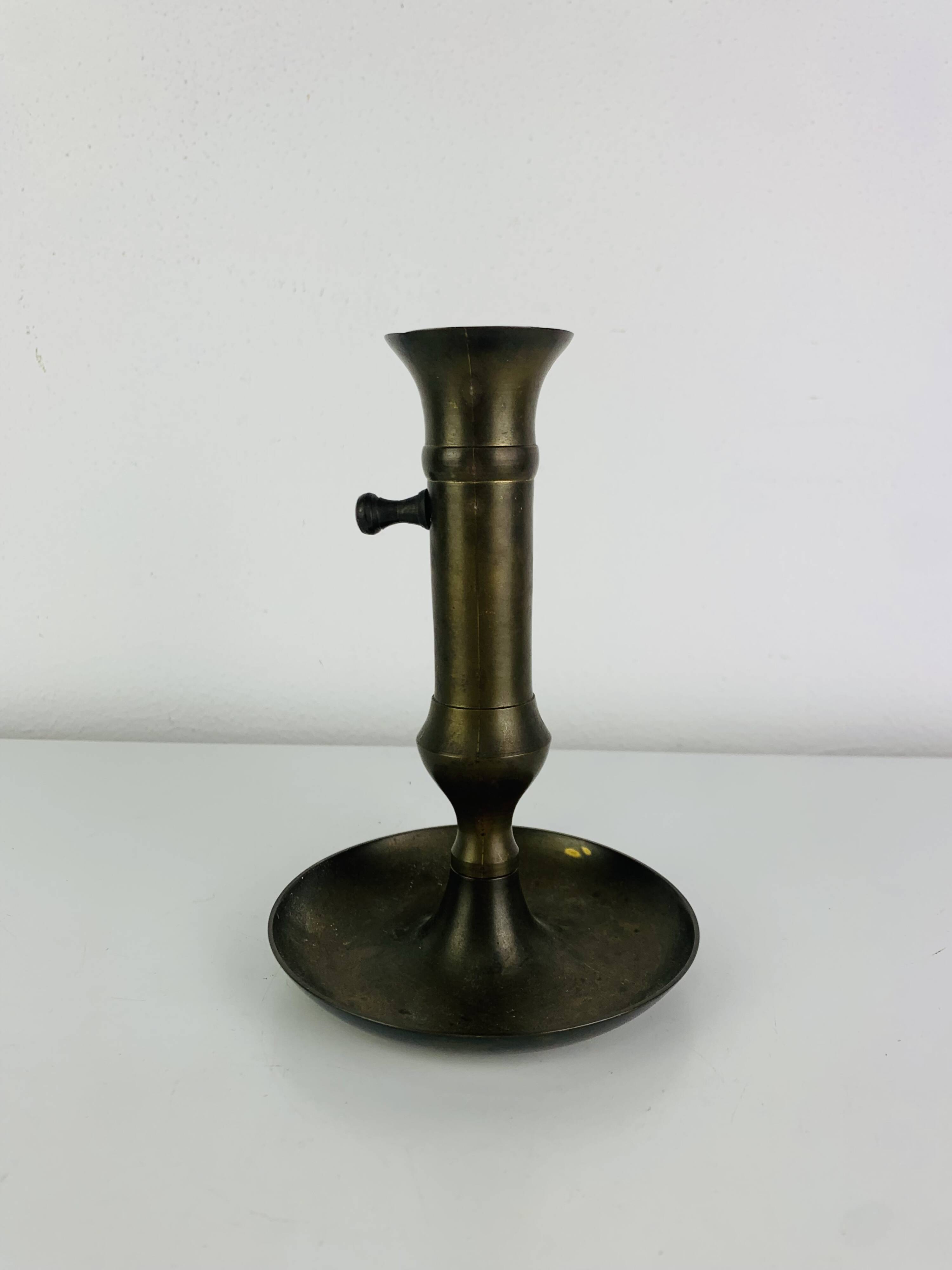 Vintage brass candlestick that raises and lowers.