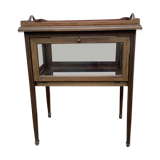 Glass-enclosed old tea table with wooden tray, bronze and brass