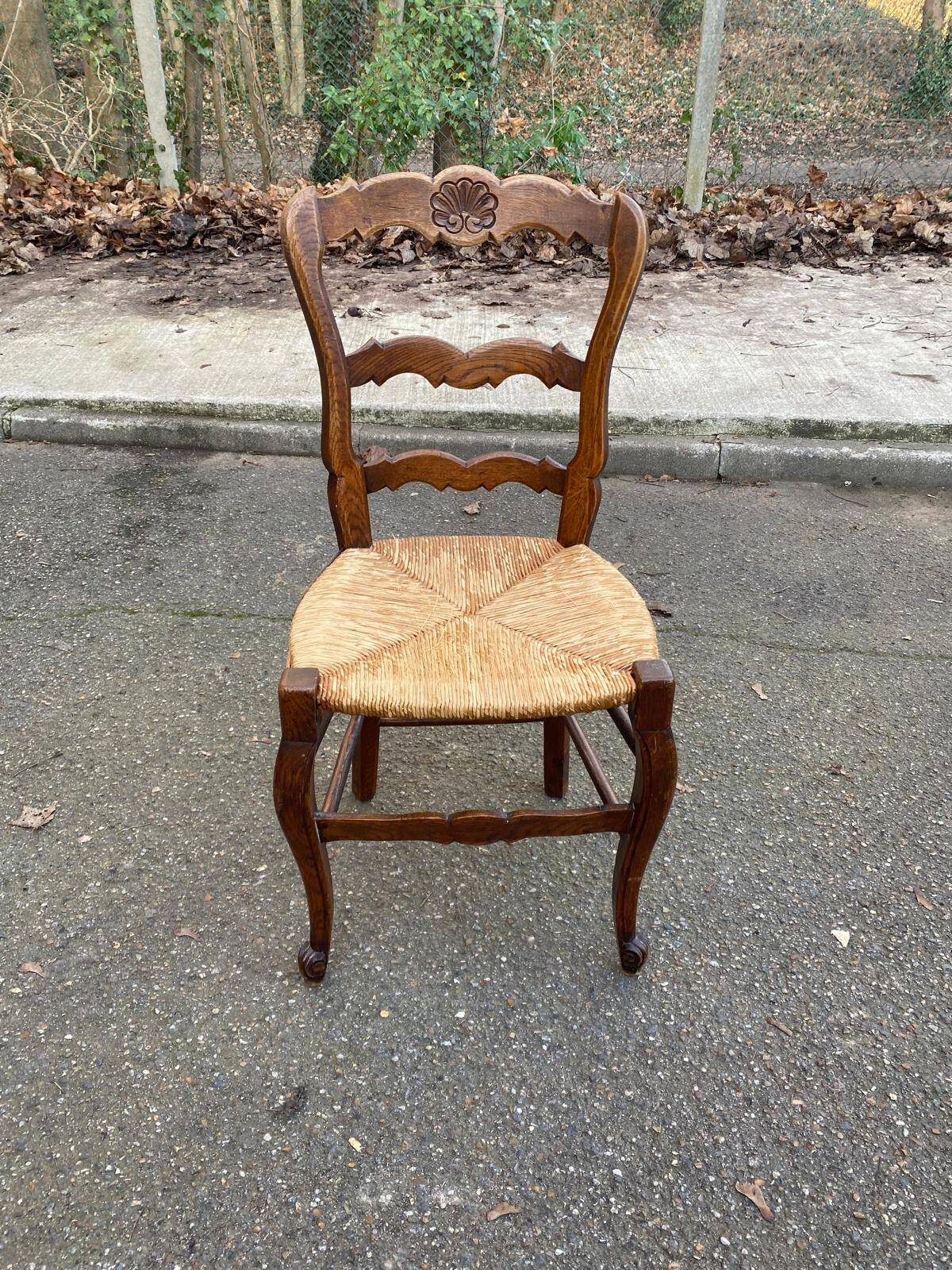 Louis XV 18th century solid wood dining chair with a straw seat.