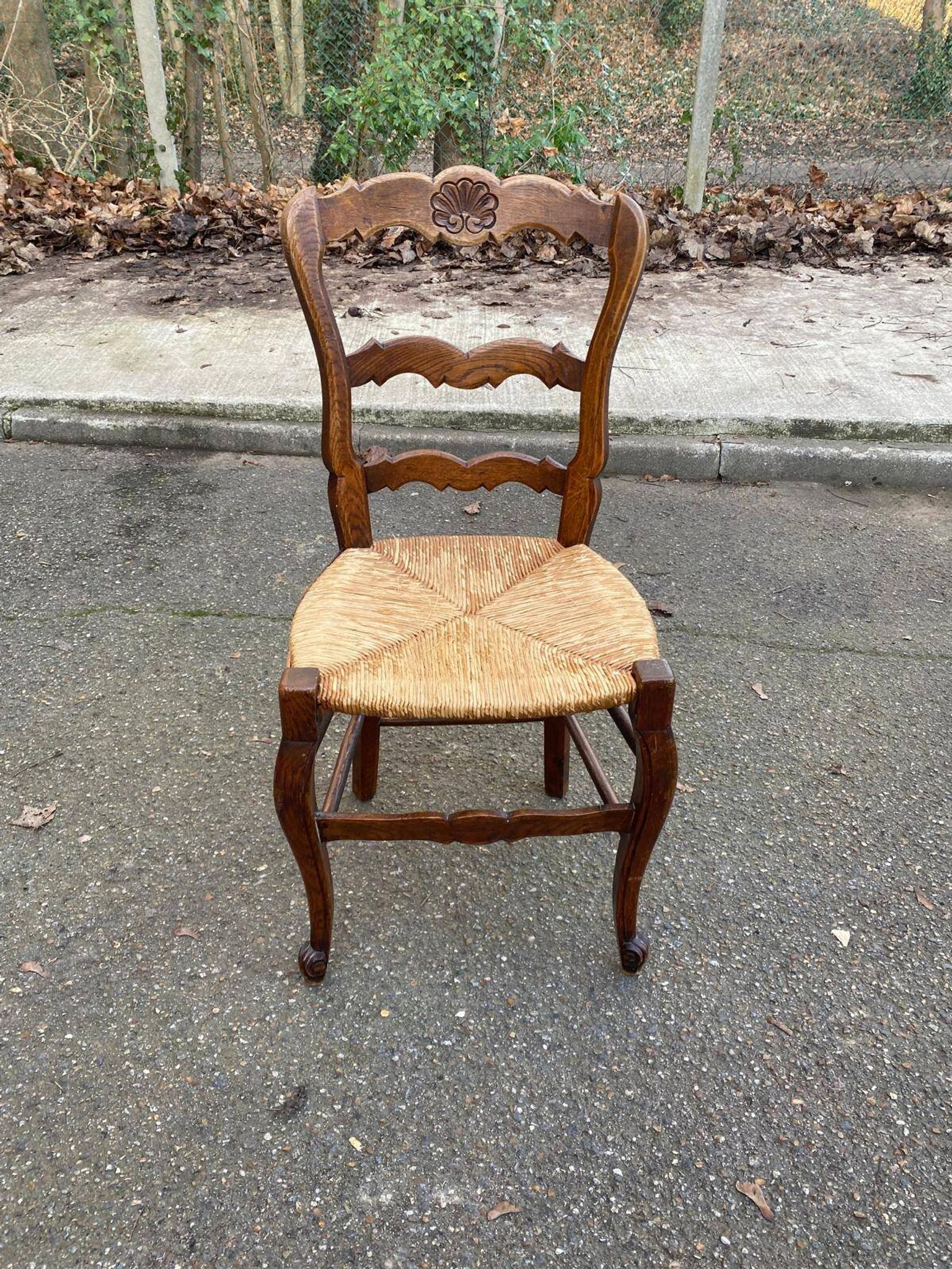 Louis XV 18th century solid wood dining chair with a straw seat.