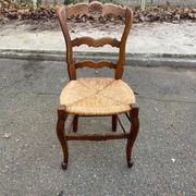 Louis XV 18th century solid wood dining chair with a straw seat.