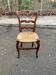 Louis XV 18th century solid wood dining chair with a straw seat.