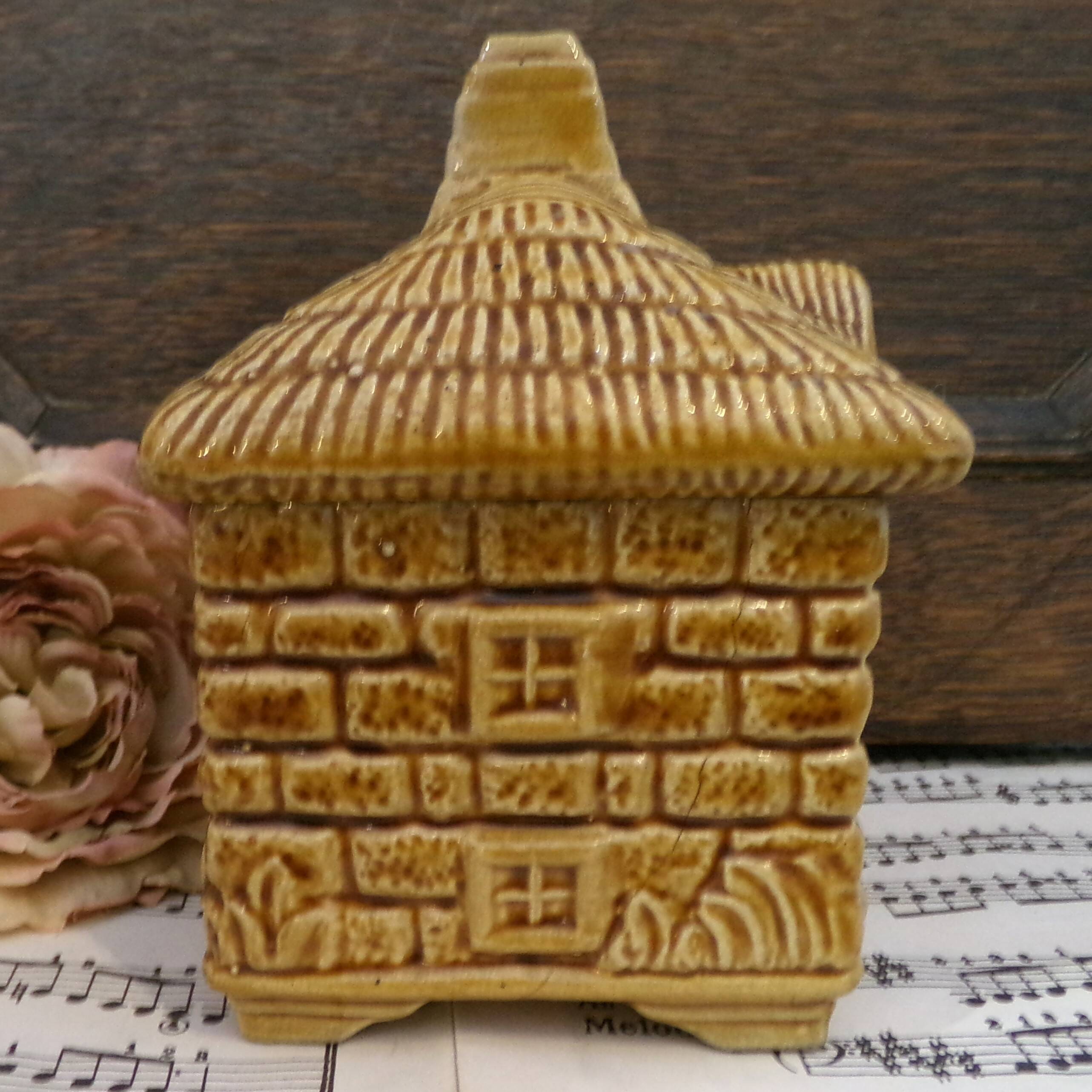 Devonway jam pot in the shape of a cottage with a thatched roof.