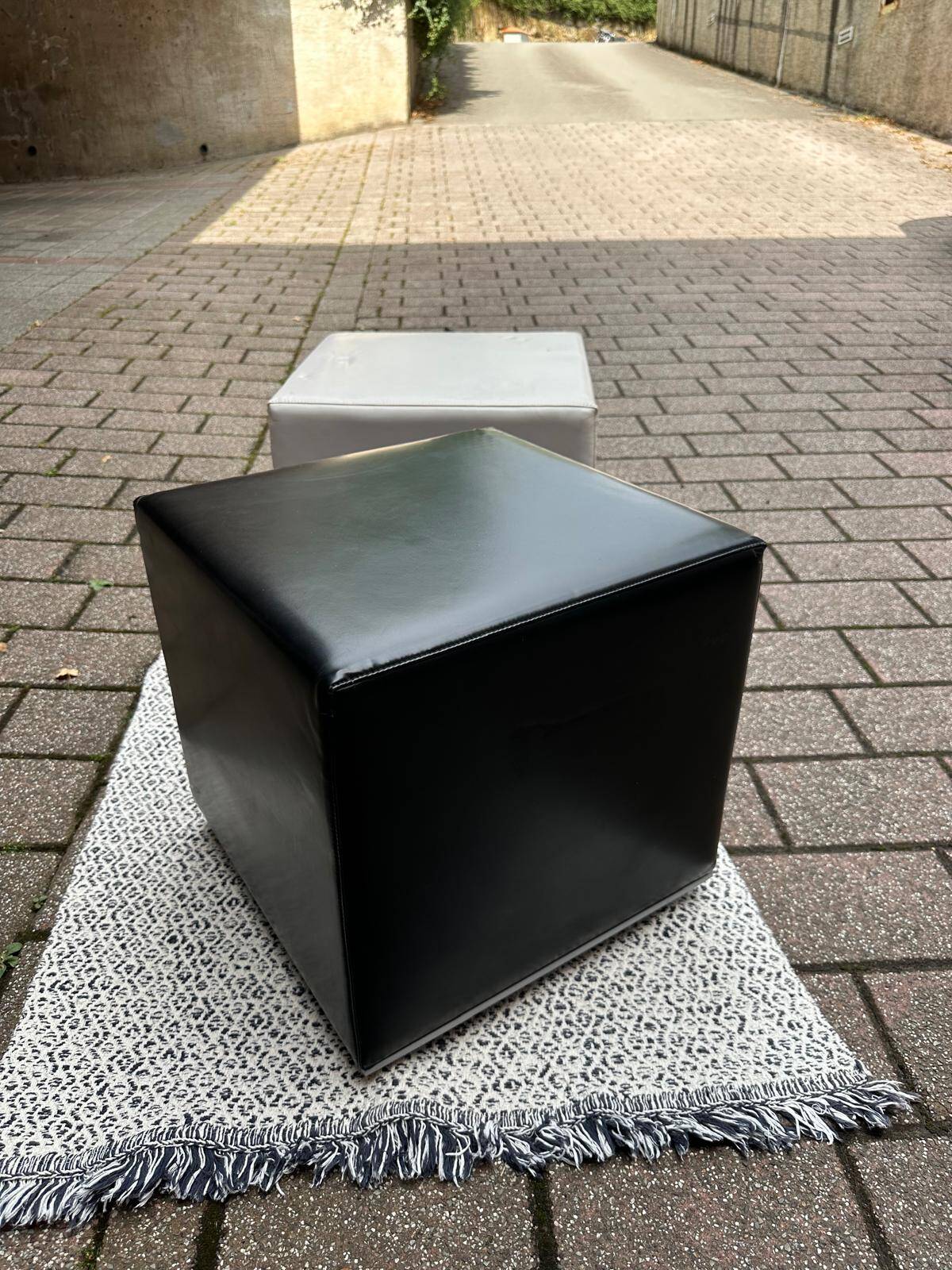 Pair of designer poufs in faux leather