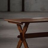 Solid oak dining table with cross base by Danish cabinetmaker, mid-20th century.