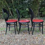6 vintage Baumann seagull model chairs, black lacquered with red Skai seats.