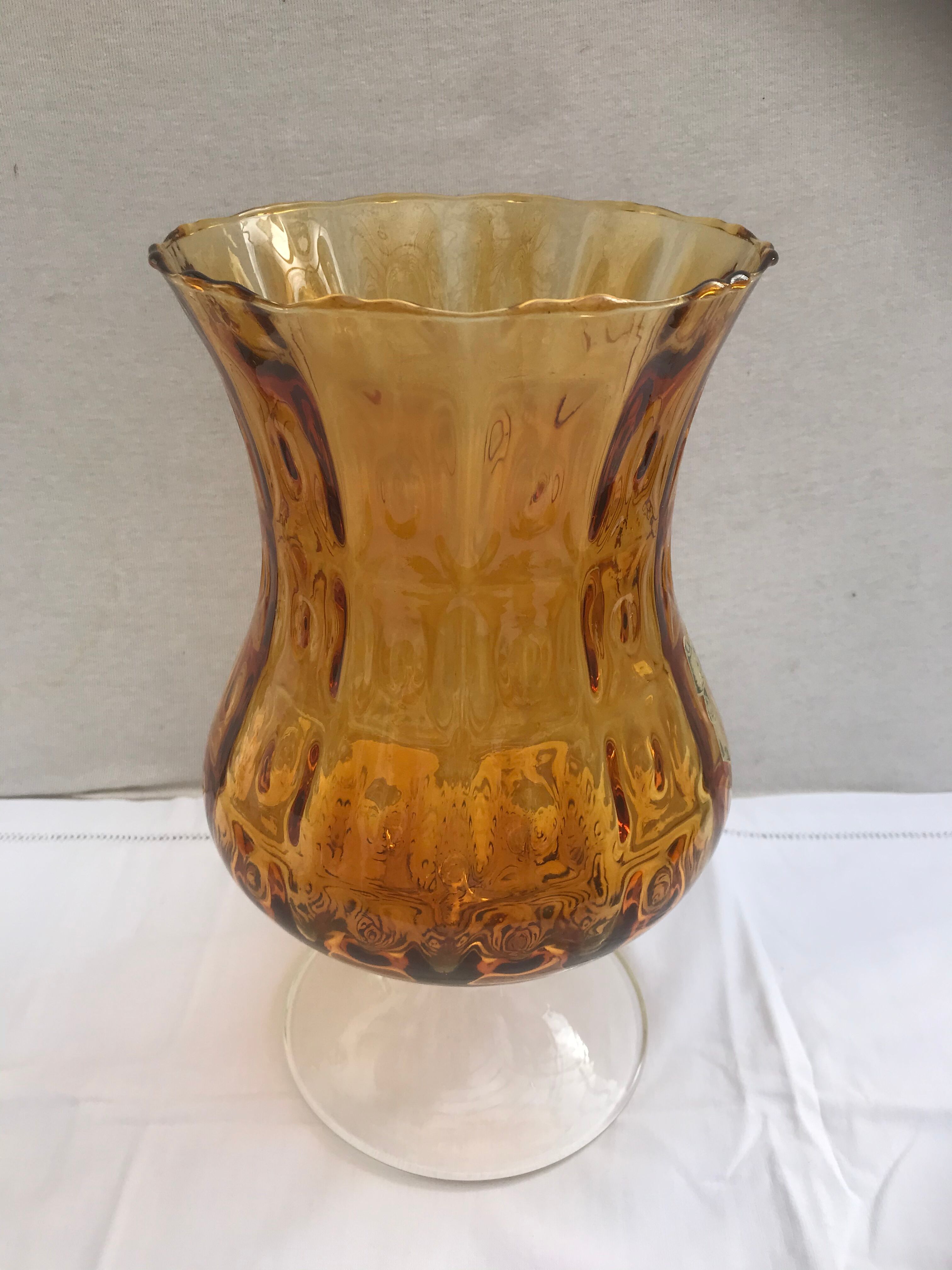 Ancient vase on foot orange glass